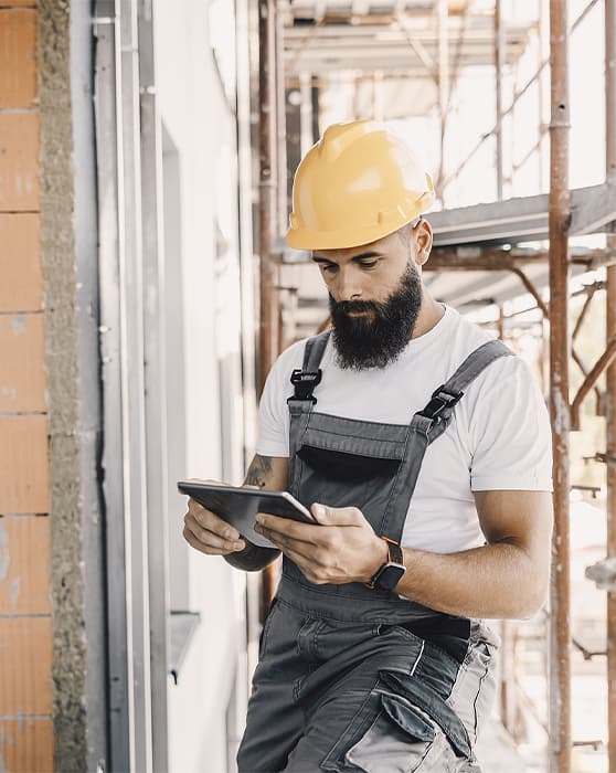 A commercial contractor checks his tablet