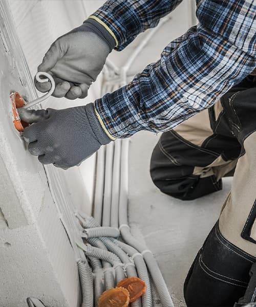 A commercial electrician installs wiring
