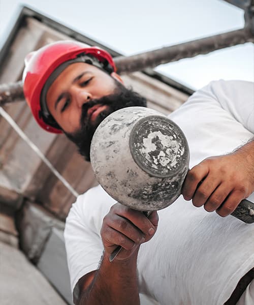 A commercial restoration specialist works with mortar