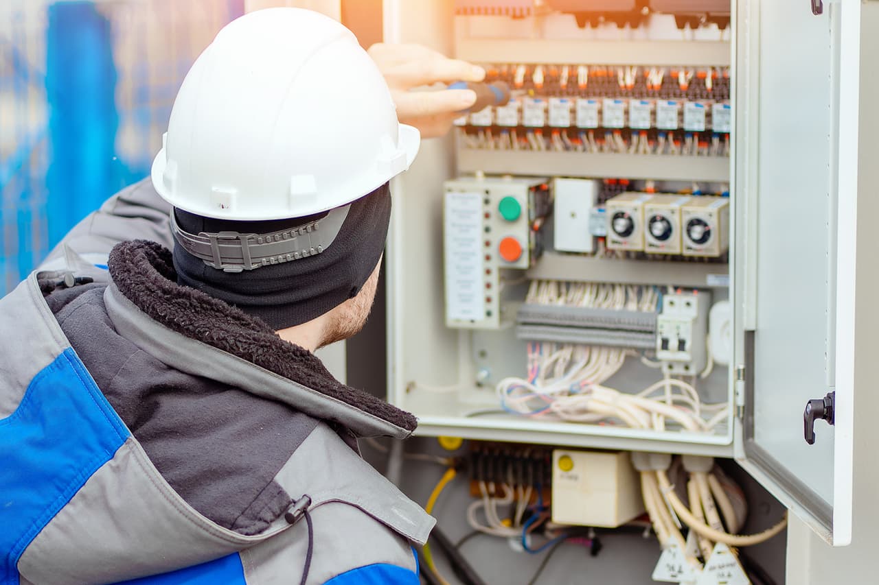 An electrician works at a commercial jobsite