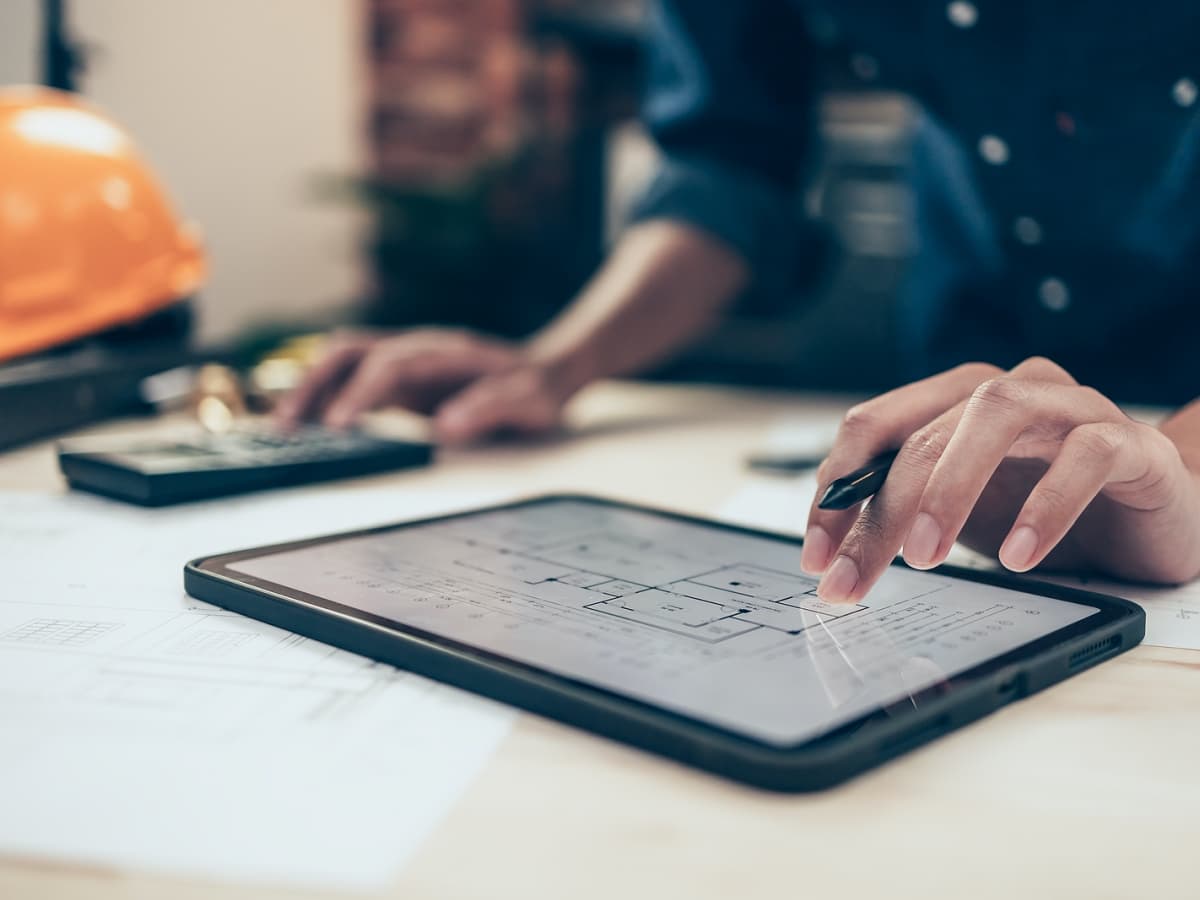 Construction manager using tablet to look at blueprints.