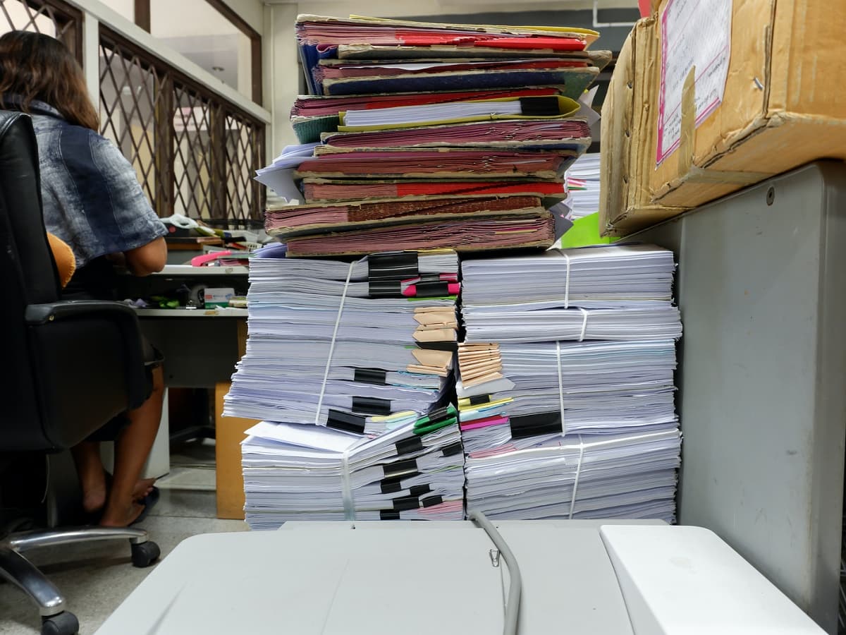 A pile of business papers, neatly stacked and waiting to be sorted or reviewed.